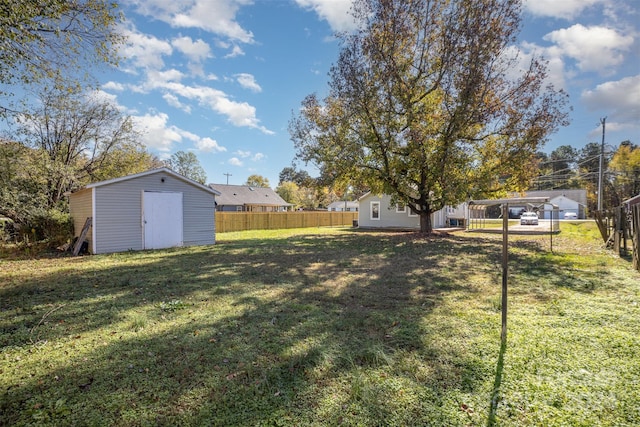 view of yard featuring a carport and a shed