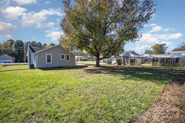 view of yard featuring a carport and central AC