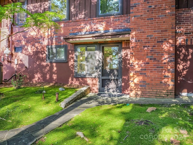 doorway to property featuring a yard