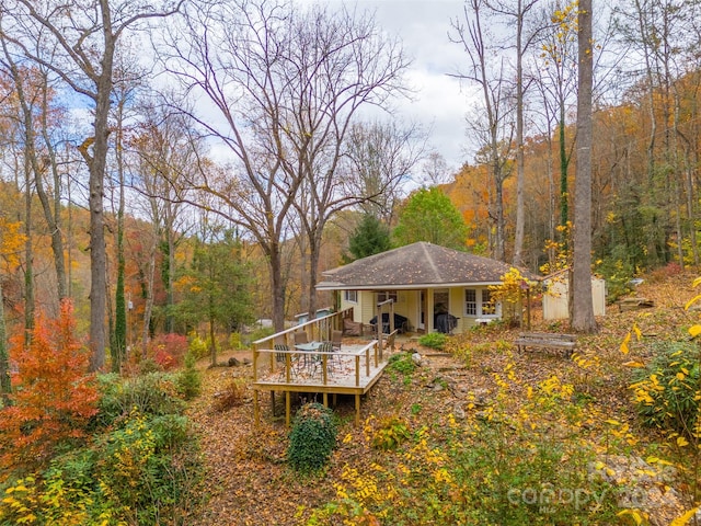 rear view of property featuring a deck