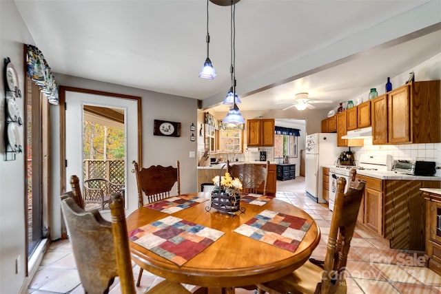 tiled dining room featuring ceiling fan