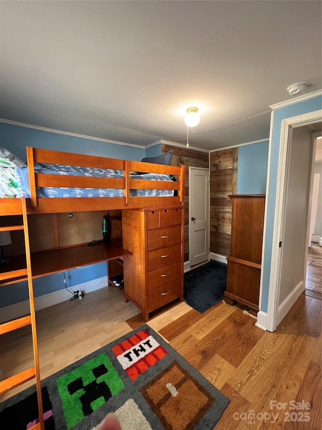 unfurnished bedroom featuring light wood-style flooring and crown molding