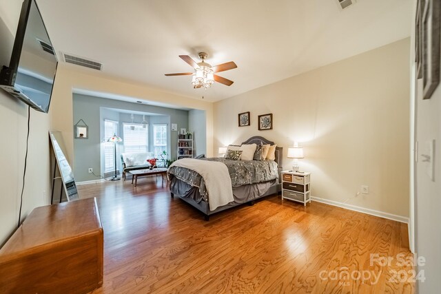 bedroom with ceiling fan and hardwood / wood-style flooring