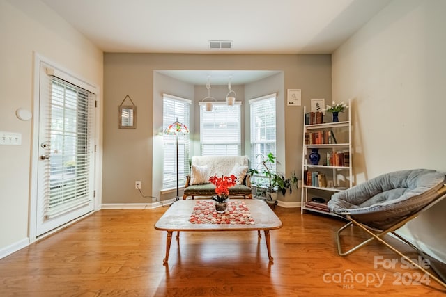 sitting room with a notable chandelier and wood-type flooring