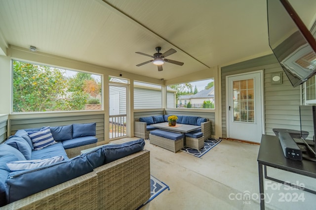 sunroom / solarium with ceiling fan, a healthy amount of sunlight, and vaulted ceiling