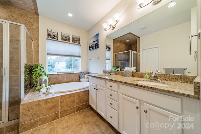 bathroom featuring shower with separate bathtub, vanity, and tile patterned floors