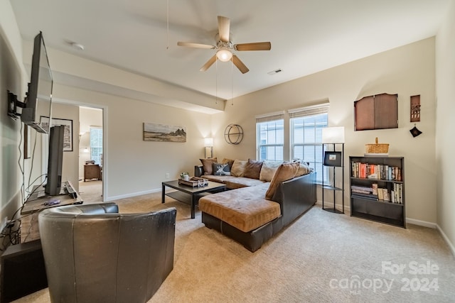 carpeted living room with ceiling fan