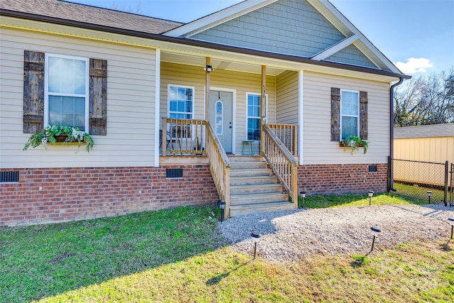 view of front of property featuring covered porch and a front yard