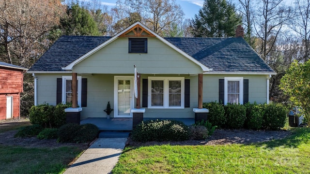 view of front of property featuring a front lawn and covered porch