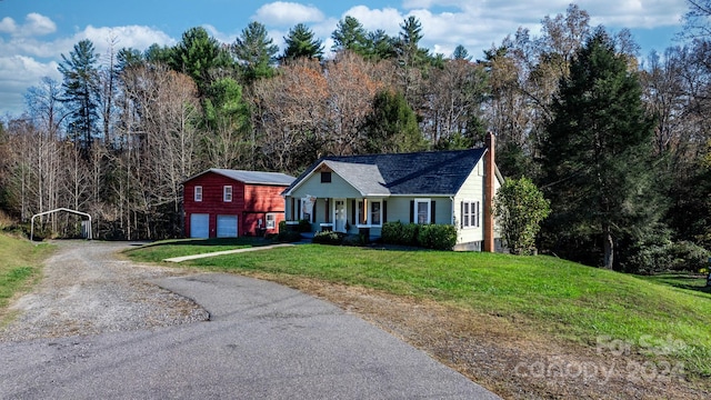 view of front of property with a front lawn, a porch, and a garage