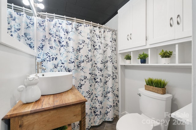 bathroom featuring vanity, tile patterned flooring, a shower with shower curtain, and toilet