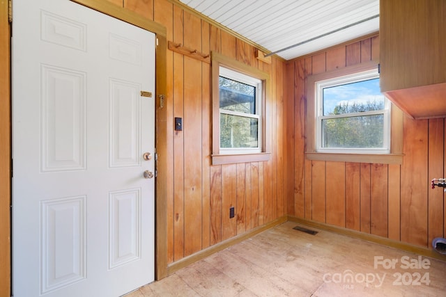 interior space featuring a wealth of natural light and wooden walls