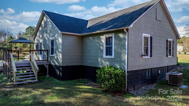 view of home's exterior featuring a gazebo, a wooden deck, a yard, and central AC