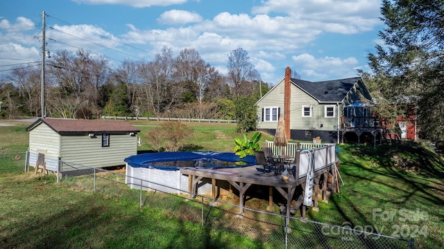 exterior space with a storage shed, a yard, and a deck