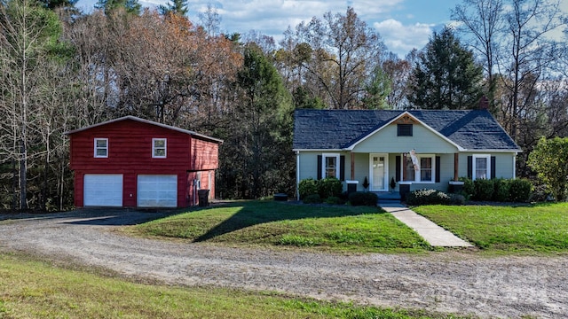 view of front of house featuring a front lawn, covered porch, and a garage