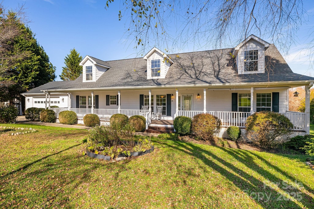 new england style home featuring covered porch and a front yard