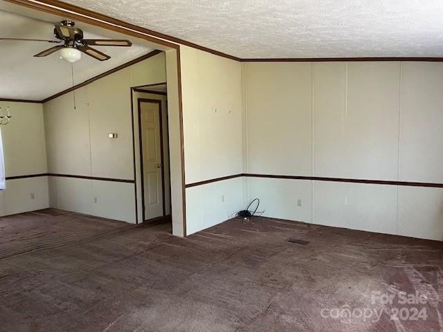 carpeted spare room with a textured ceiling, ceiling fan, lofted ceiling, and ornamental molding