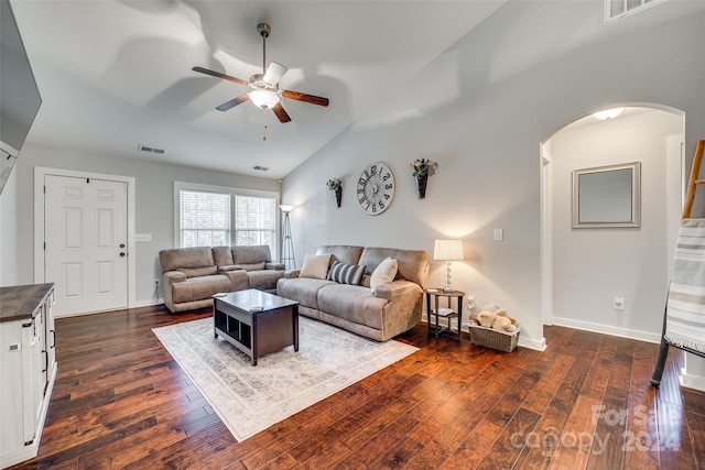 living room featuring ceiling fan, dark hardwood / wood-style floors, and vaulted ceiling