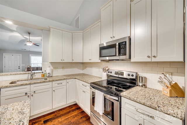 kitchen featuring white cabinets, sink, dark hardwood / wood-style floors, appliances with stainless steel finishes, and tasteful backsplash