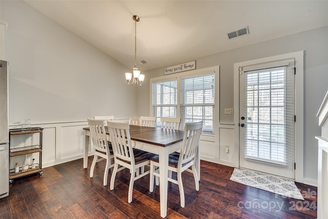 dining space with dark hardwood / wood-style flooring, plenty of natural light, and a notable chandelier