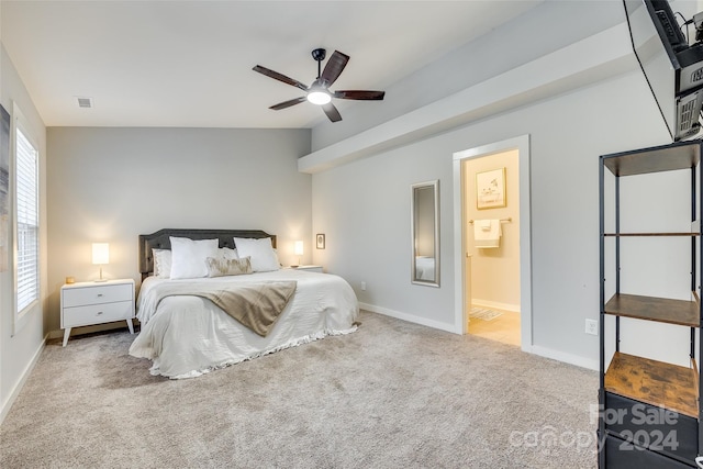 bedroom with ensuite bath, ceiling fan, carpet, and vaulted ceiling