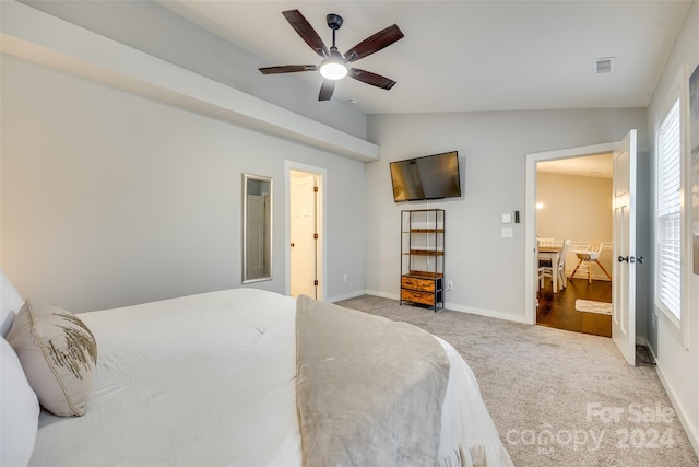 bedroom with light colored carpet, ceiling fan, and lofted ceiling