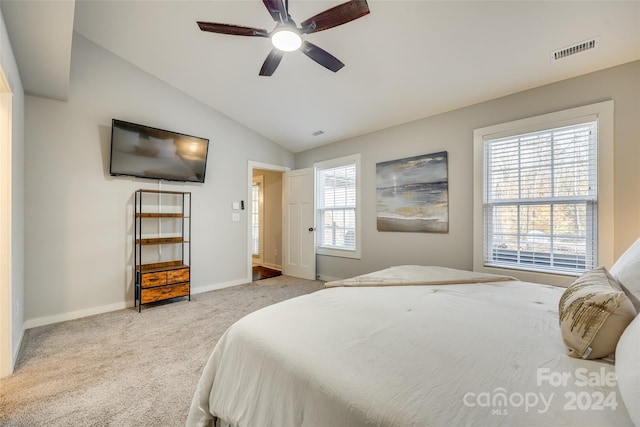 carpeted bedroom with vaulted ceiling and ceiling fan