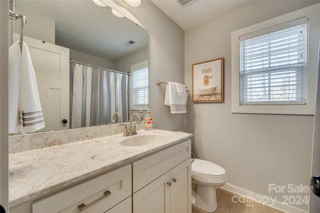 bathroom with tile patterned floors, vanity, and toilet