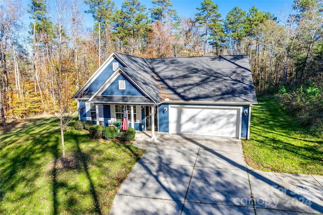 view of front property featuring a porch, a garage, and a front lawn