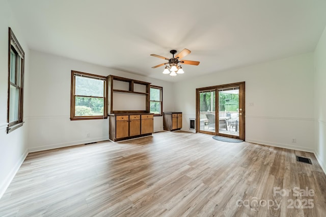 2109 Rock Springs Cir, Denver, NC 28037 - unfurnished living room featuring a ceiling fan, light wood-style floors, and baseboards