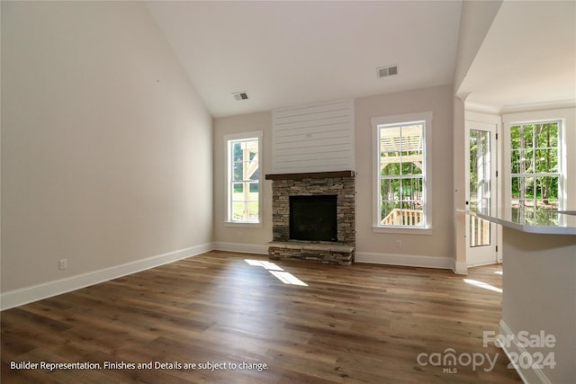 unfurnished living room featuring a fireplace, dark hardwood / wood-style flooring, and vaulted ceiling