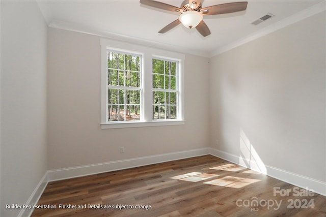 empty room featuring ceiling fan, dark hardwood / wood-style flooring, and ornamental molding