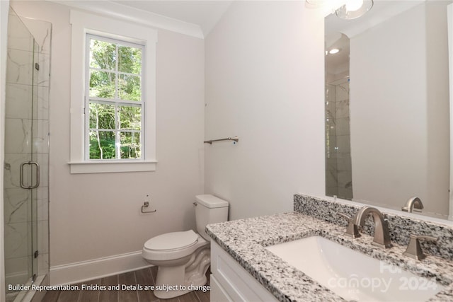 bathroom with hardwood / wood-style floors, toilet, vanity, a shower with shower door, and ornamental molding