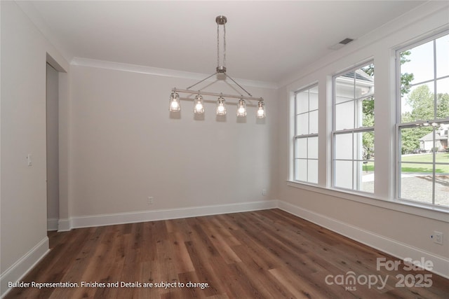 unfurnished dining area featuring wood finished floors, ornamental molding, and a healthy amount of sunlight