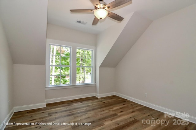 bonus room with lofted ceiling, baseboards, wood finished floors, and visible vents