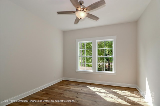empty room with baseboards, a ceiling fan, and wood finished floors