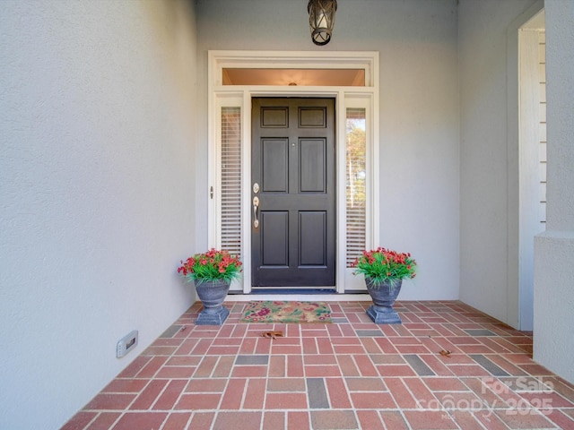 doorway to property with stucco siding