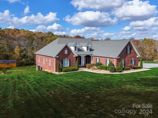 cape cod home with central AC and a front lawn