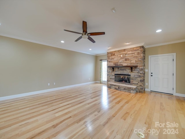 unfurnished living room with a fireplace, ceiling fan, light wood-type flooring, and ornamental molding