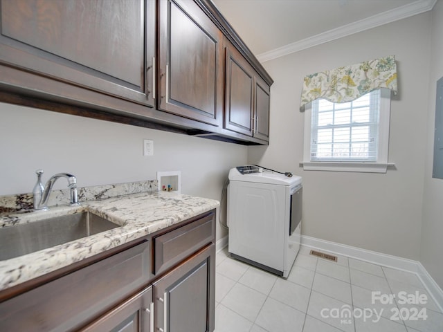 laundry area featuring cabinets, crown molding, sink, light tile patterned floors, and washer / clothes dryer