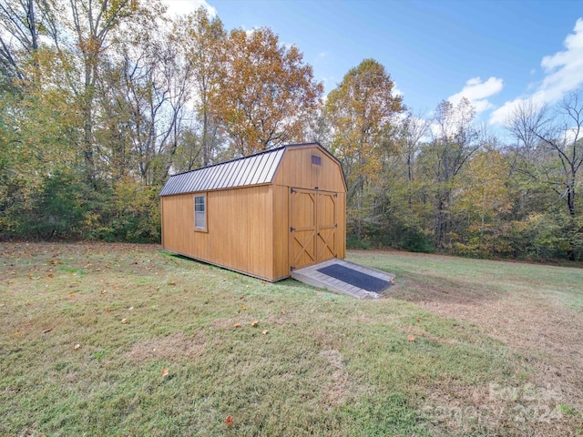 view of outdoor structure featuring a lawn