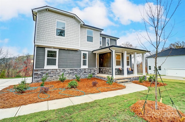 view of front of house with a porch and a front lawn