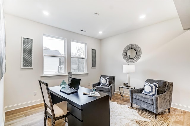 home office with light hardwood / wood-style floors