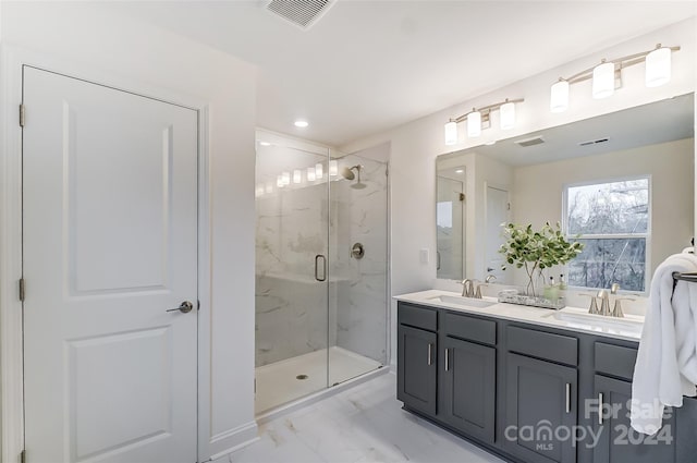 bathroom with vanity and a shower with door