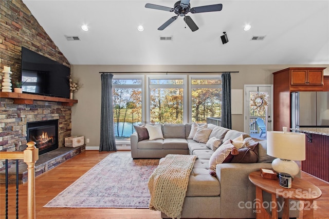 169 Rimmer Farm Rd, Troutman, NC 28166 - living area featuring a ceiling fan, wood finished floors, a stone fireplace, recessed lighting, and high vaulted ceiling