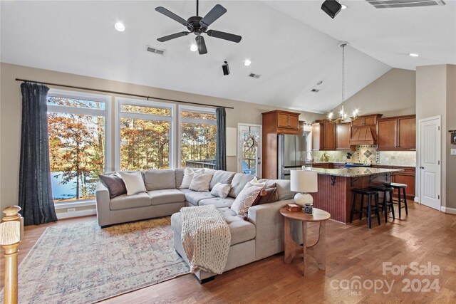 169 Rimmer Farm Rd, Troutman, NC 28166 - living room with a chandelier, plenty of natural light, light wood finished floors, high vaulted ceiling, and recessed lighting