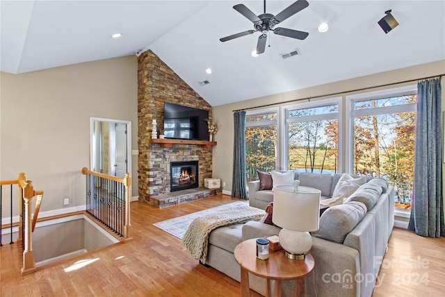 169 Rimmer Farm Rd, Troutman, NC 28166 - living area featuring high vaulted ceiling, wood finished floors, baseboards, and a stone fireplace