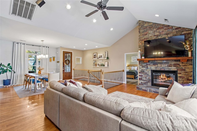 169 Rimmer Farm Rd, Troutman, NC 28166 - living area featuring a ceiling fan, light wood finished floors, a fireplace, a chandelier, and high vaulted ceiling