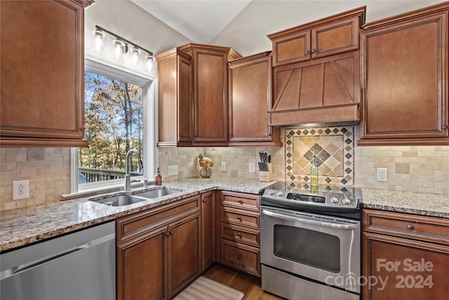 169 Rimmer Farm Rd, Troutman, NC 28166 - kitchen featuring appliances with stainless steel finishes, a sink, light stone counters, wood finished floors, and tasteful backsplash