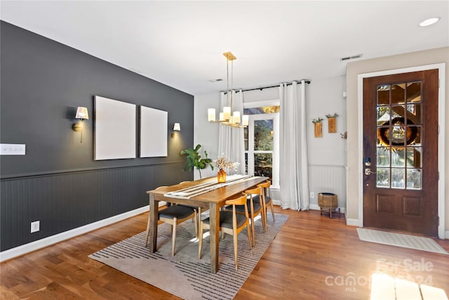 169 Rimmer Farm Rd, Troutman, NC 28166 - dining area featuring wood finished floors, a chandelier, and a wainscoted wall